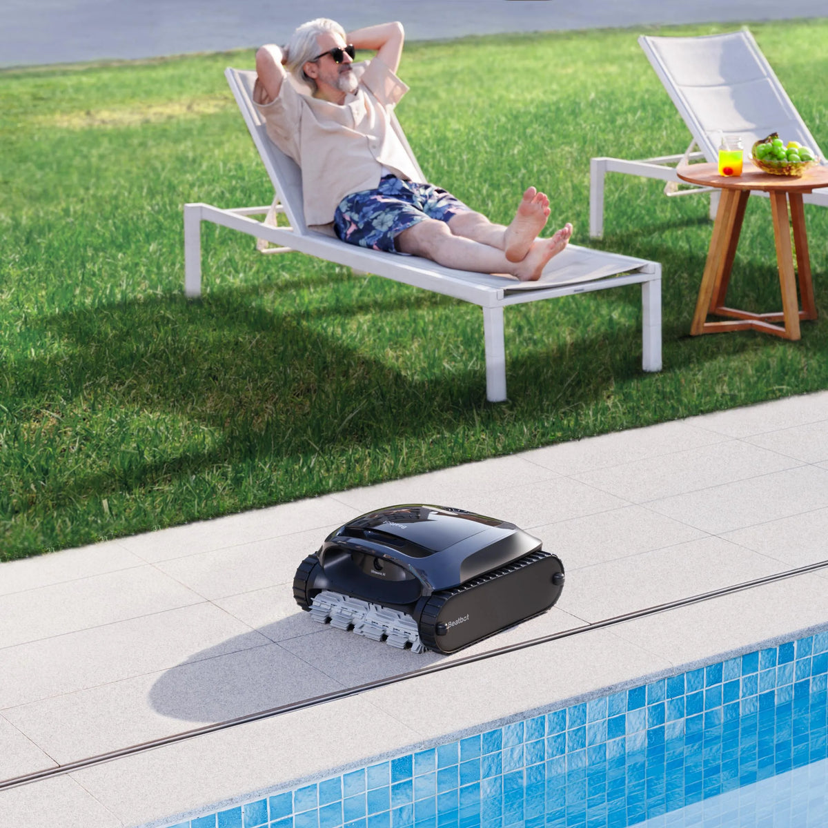 Beatbot AquaSense 2 on a pool deck while a man relaxes on a lounger