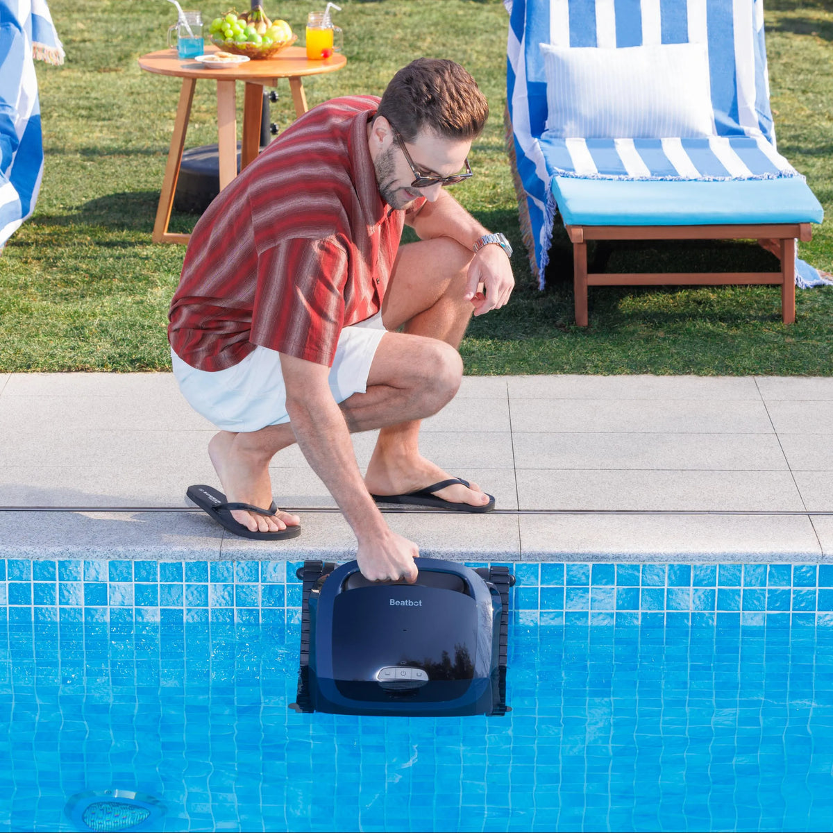 Man lowering a Beatbot AquaSense 2 into a pool