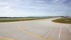Airport taxiway with yellow centerline marking
