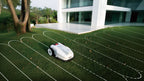 FJD FV2000 mowing a lawn in a pattern beside a modern house
