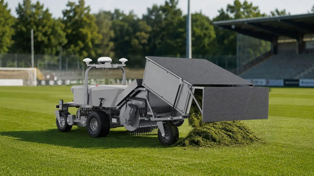 FJD robotic mower with GC01 grass collector kit unloading clippings on a stadium field
