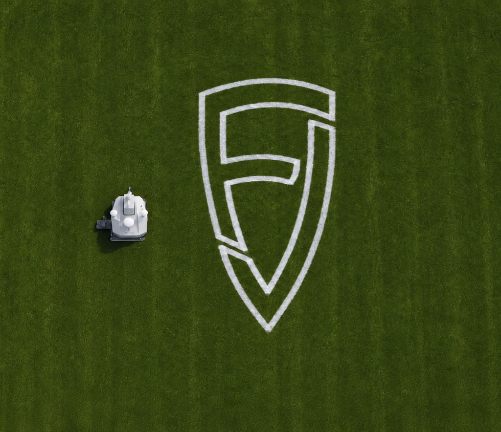 FJD PaintMaster Pro painting a large logo on turf, aerial view