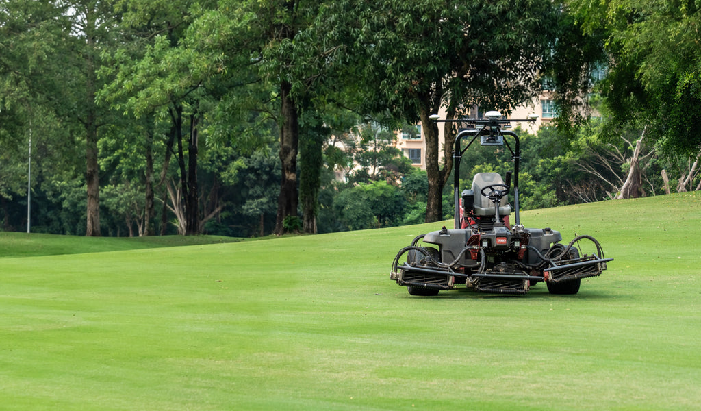 Fairway reel mower retrofitted with the FJD ATX kit mowing between trees