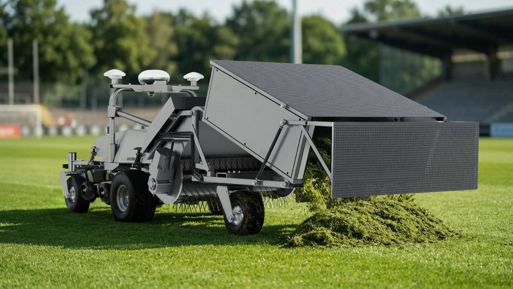 FJD robotic mower with GC01 grass collector kit unloading clippings on a sports field