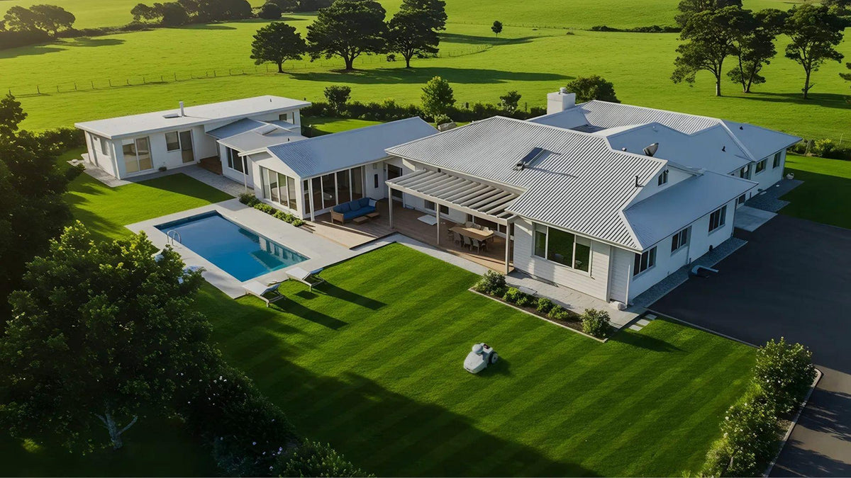FJD FR4000 robotic mower striping a large estate lawn, aerial view
