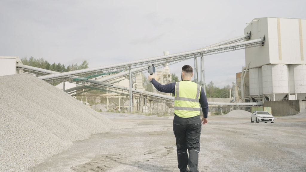 Operator scanning a material yard stockpile with the FJD Trion X1