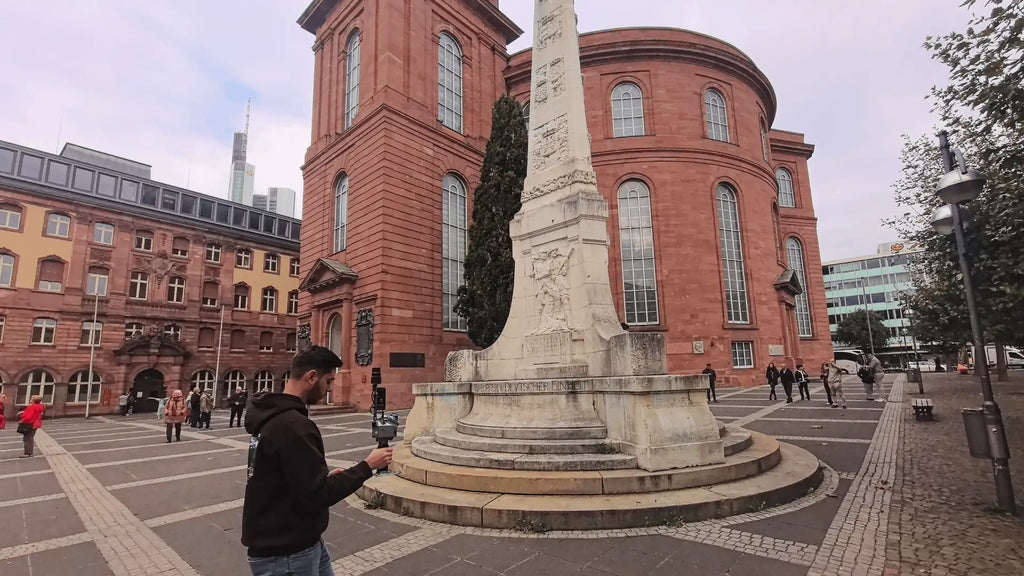 Operator scanning a historic town square with the FJD Trion P2