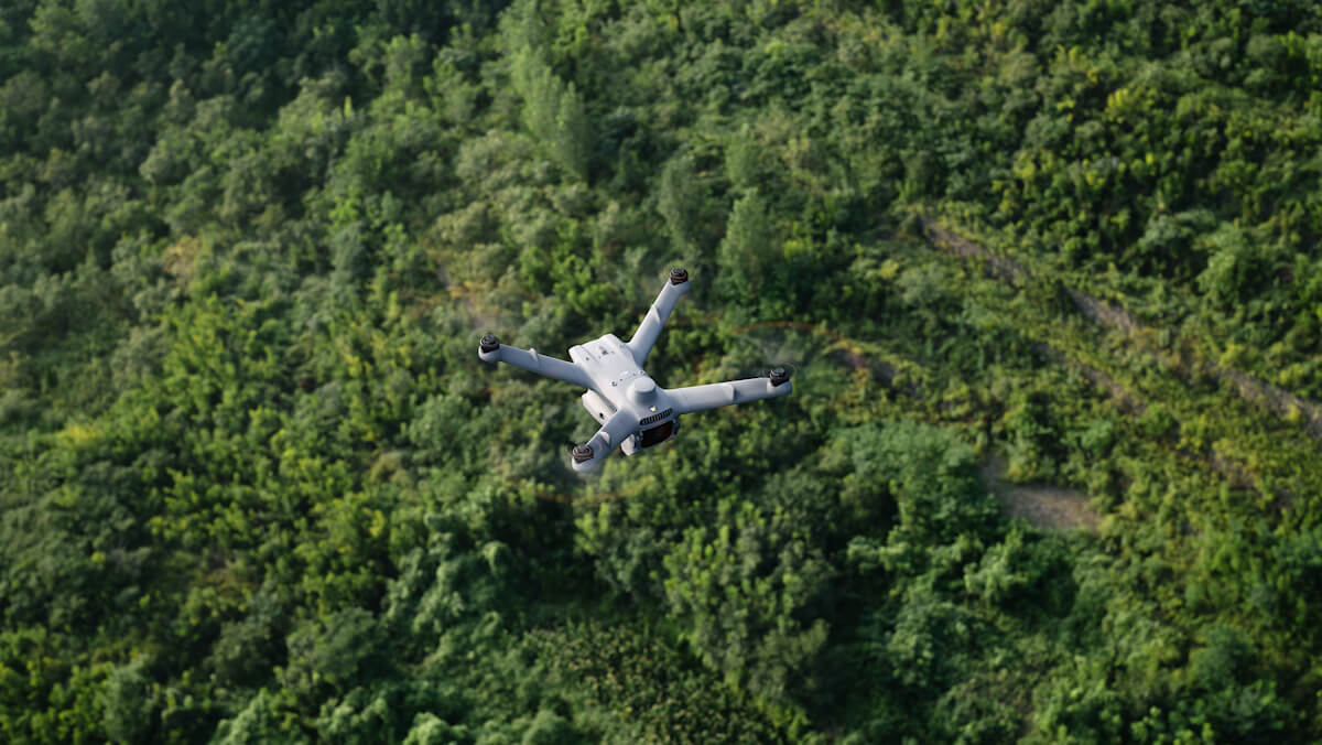 DJI Matrice 3D series drone flying over dense forest