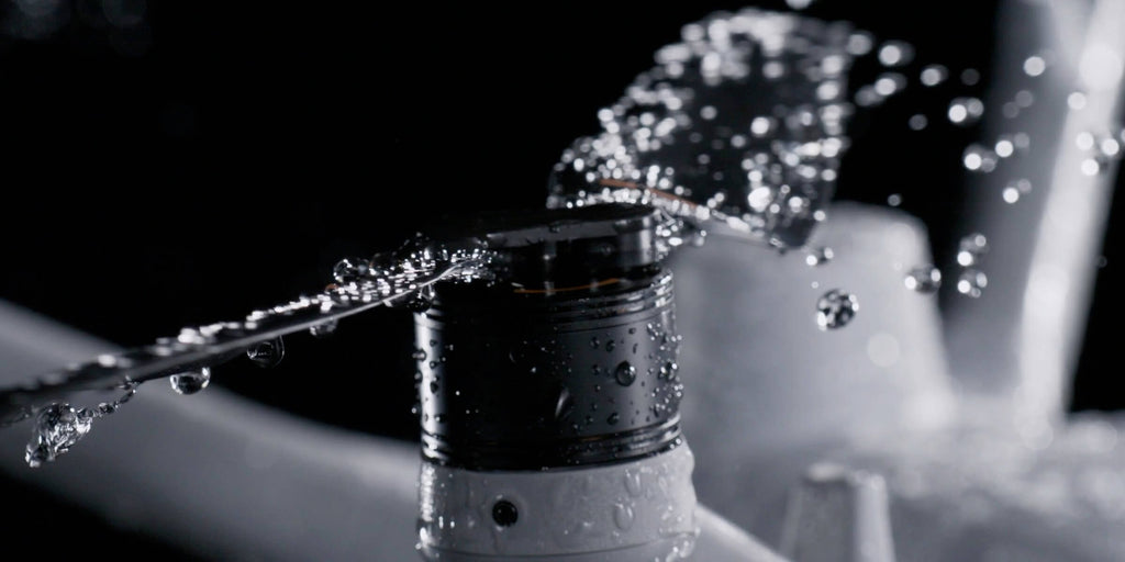 Water spraying over a DJI Matrice 4D series motor, showing IP55 water and dust resistance