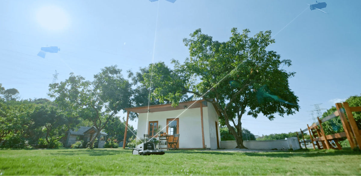 Lymow One Plus navigating a yard with RTK satellite positioning near trees and a building