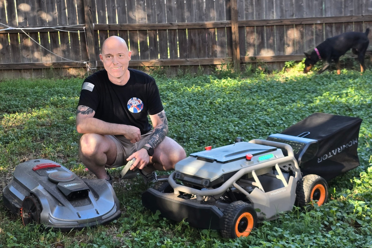 Alan Dale Russell, founder of OmniNova Home Systems, in his Texas backyard with a Sunseeker Elite X5 robotic mower and a Mowrator S1 4WD remote-control mower
