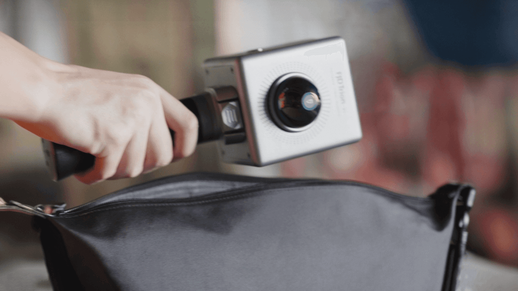 FJD Trion P1 LiDAR scanner being packed into a messenger bag