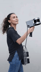 Operator holding the FJD Trion S1 3D LiDAR scanner with datalogger on a shoulder strap